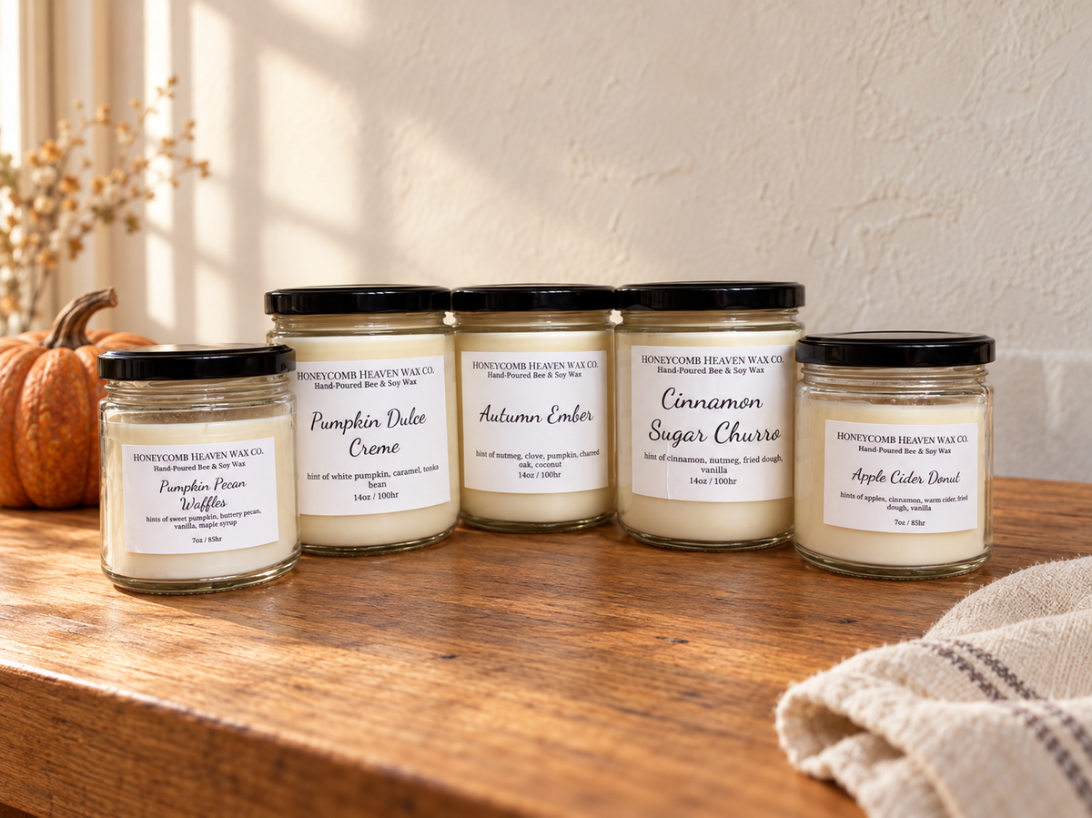 Five HoneyComb Heaven fall candles on a wooden table beside a pumpkin